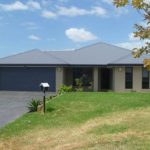 House with Black Roof Iyons with White Roof — Roofing Services in Winnellie, NT