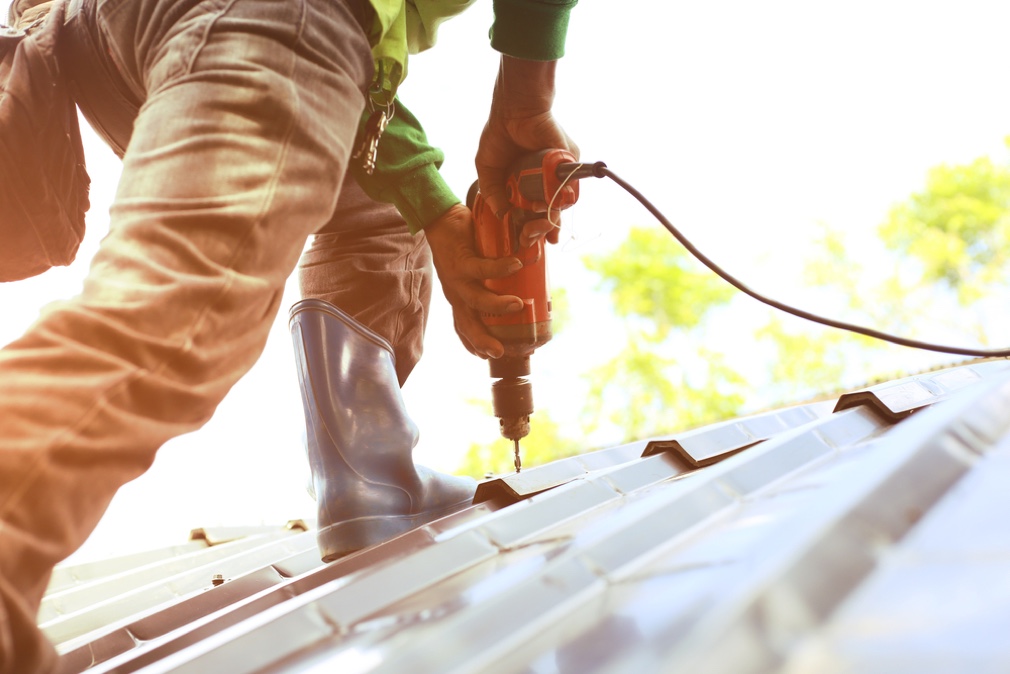 Repair Man Fixing Roof — Roofing Services in Winnellie, NT