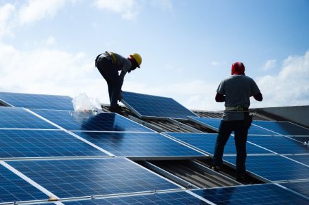 Two Man Installing Solar Panel — Roofing Services in Winnellie, NT